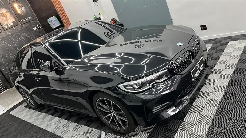BMW preta com película e adesivo Kadosh Film's no para-brisa